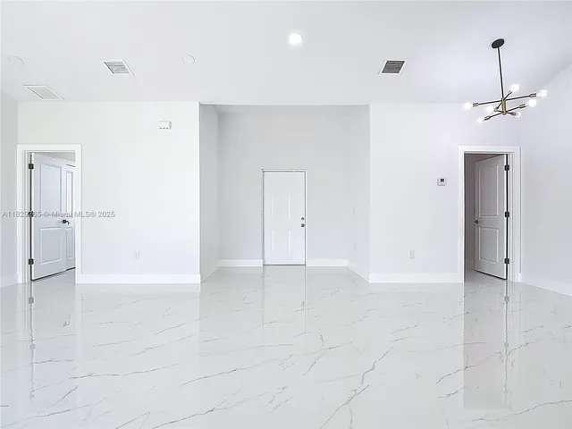 a view of a kitchen with kitchen island and windows