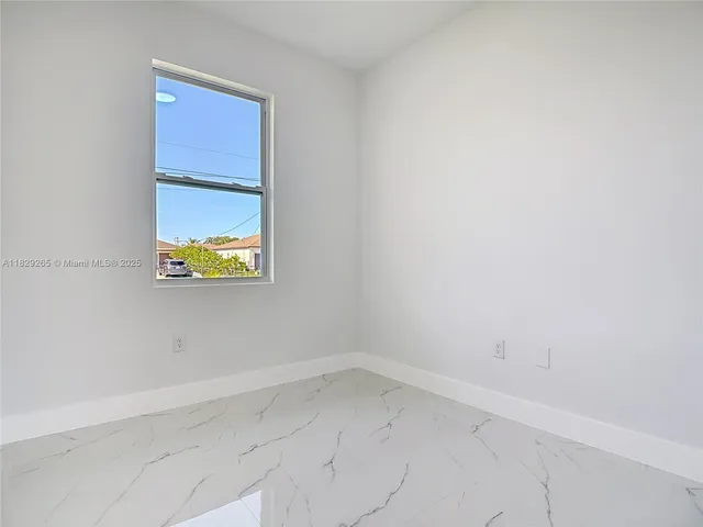 a bathroom with a granite countertop bathtub shower sink vanity and toilet