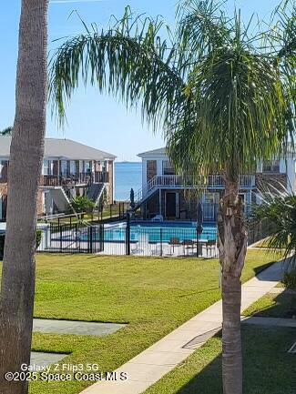 190 East Olmstead Drive, Unit E5 Titusville, FL 32780 - Photo 22 of 26 a view of swimming pool with a garden and trees