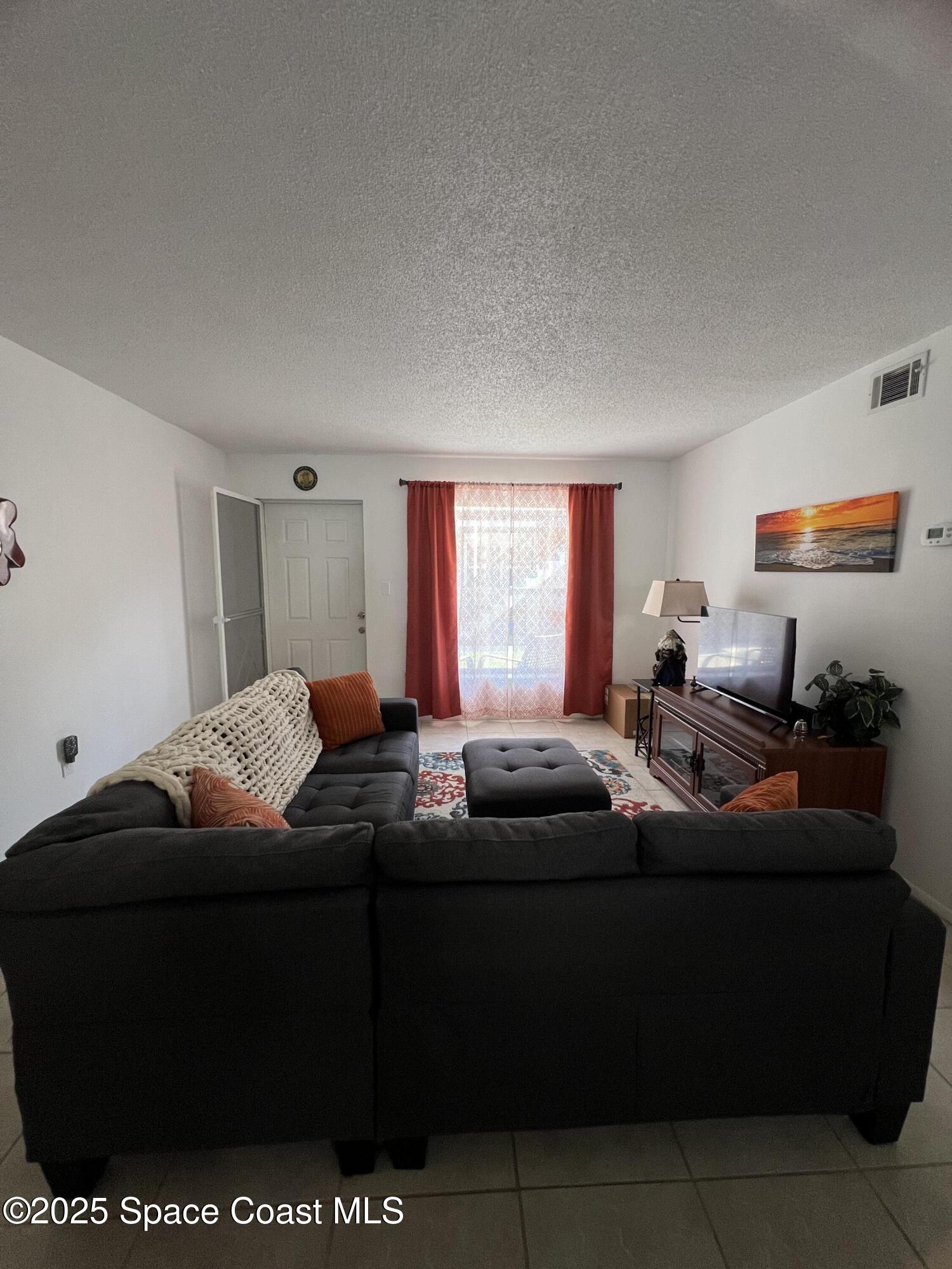 190 East Olmstead Drive, Unit E5 Titusville, FL 32780 - Photo 7 of 26 a living room with furniture