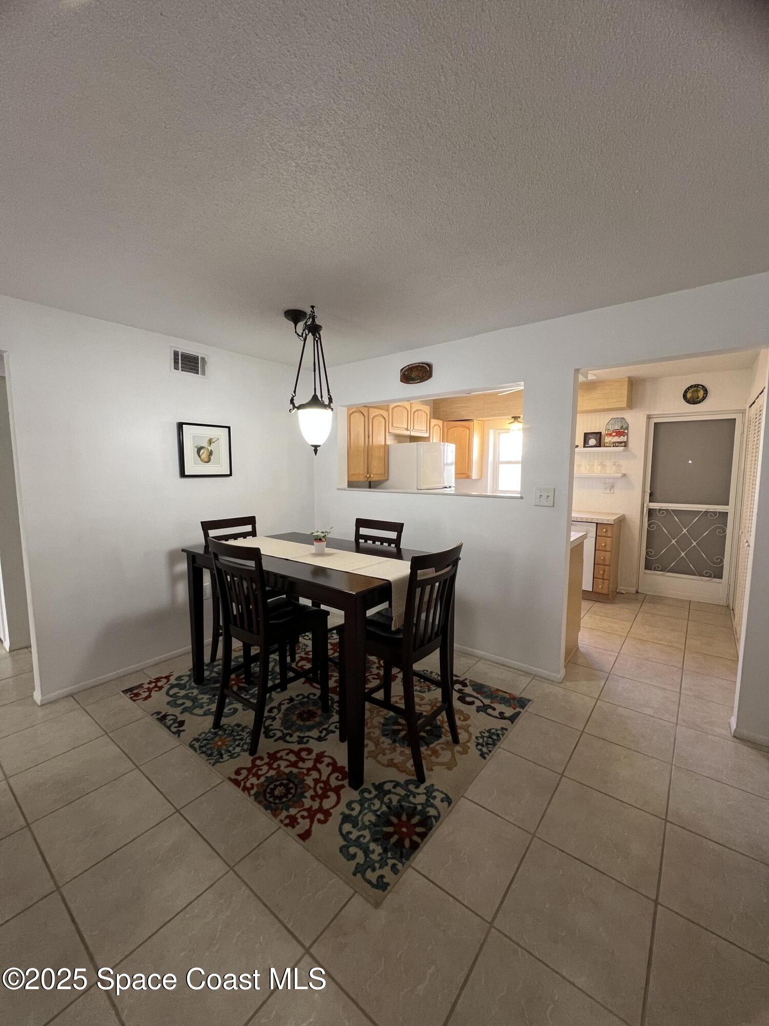 190 East Olmstead Drive, Unit E5 Titusville, FL 32780 - Photo 9 of 26 a view of a dining room with furniture