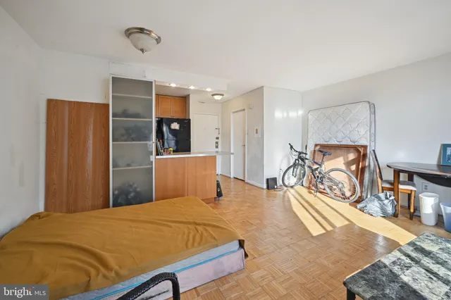 a bedroom with a bed and a large mirror