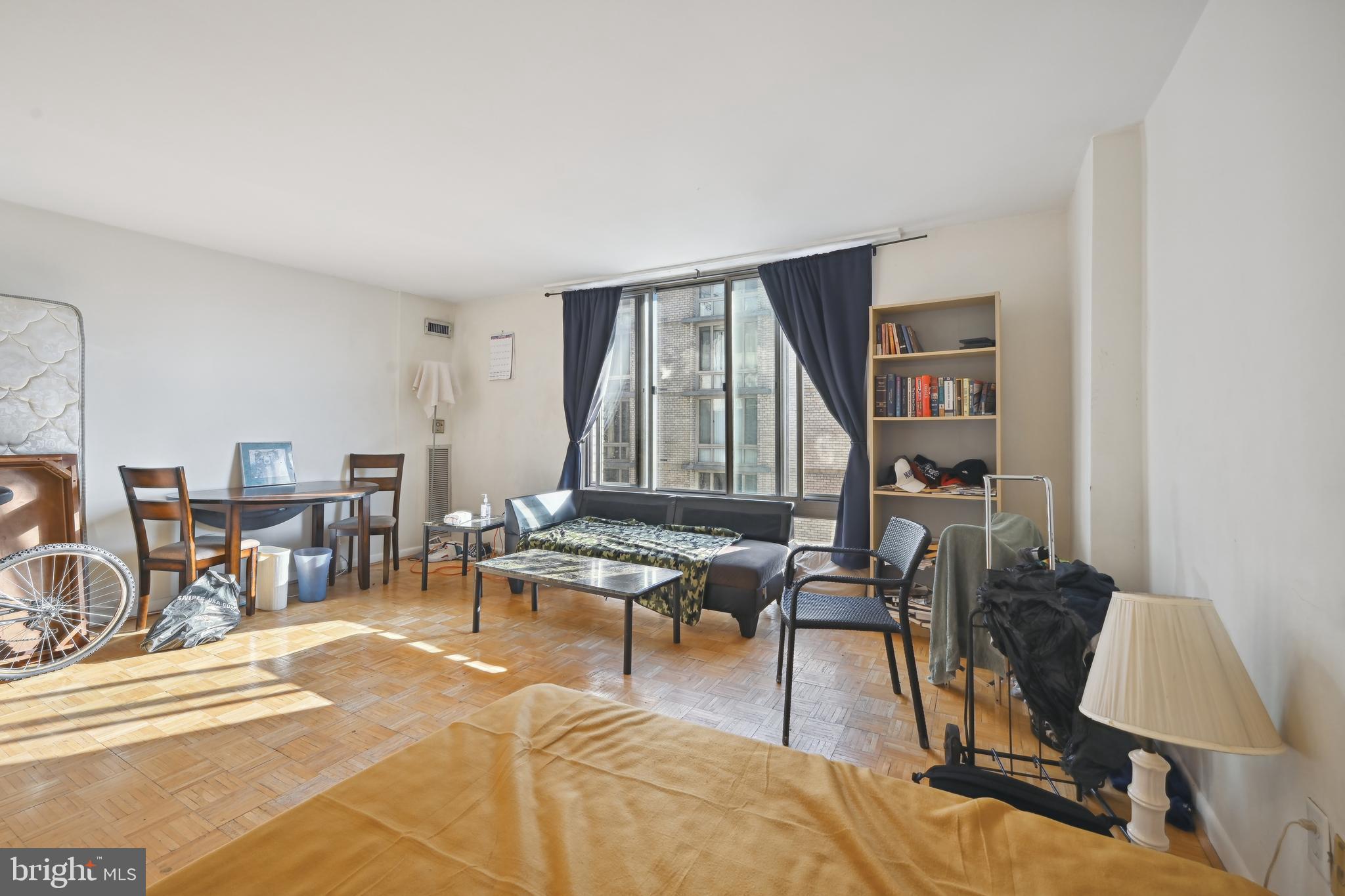 950 25th Street Northwest, Unit 814N Washington, DC 20037 - Photo 19 of 44 a living room with furniture a rug and a floor to ceiling window