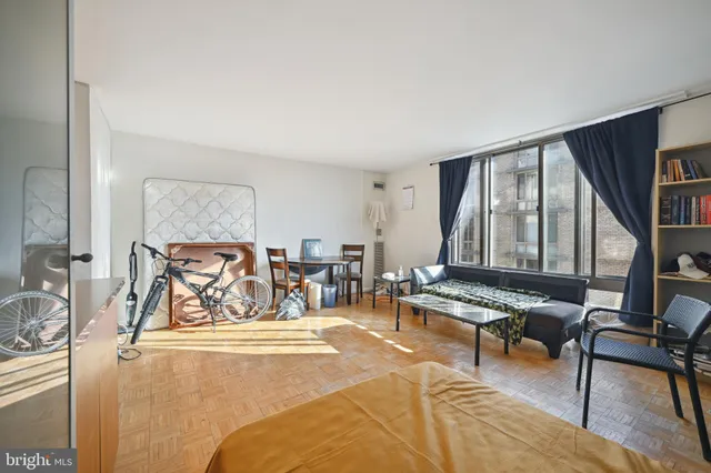 a living room with furniture and a floor to ceiling window