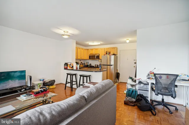 a living room with furniture and a dining table