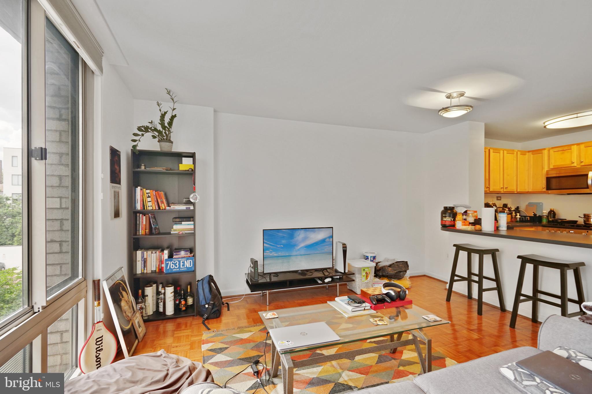 950 25th Street Northwest, Unit 814N Washington, DC 20037 - Photo 26 of 44 a living room with furniture and a dining table