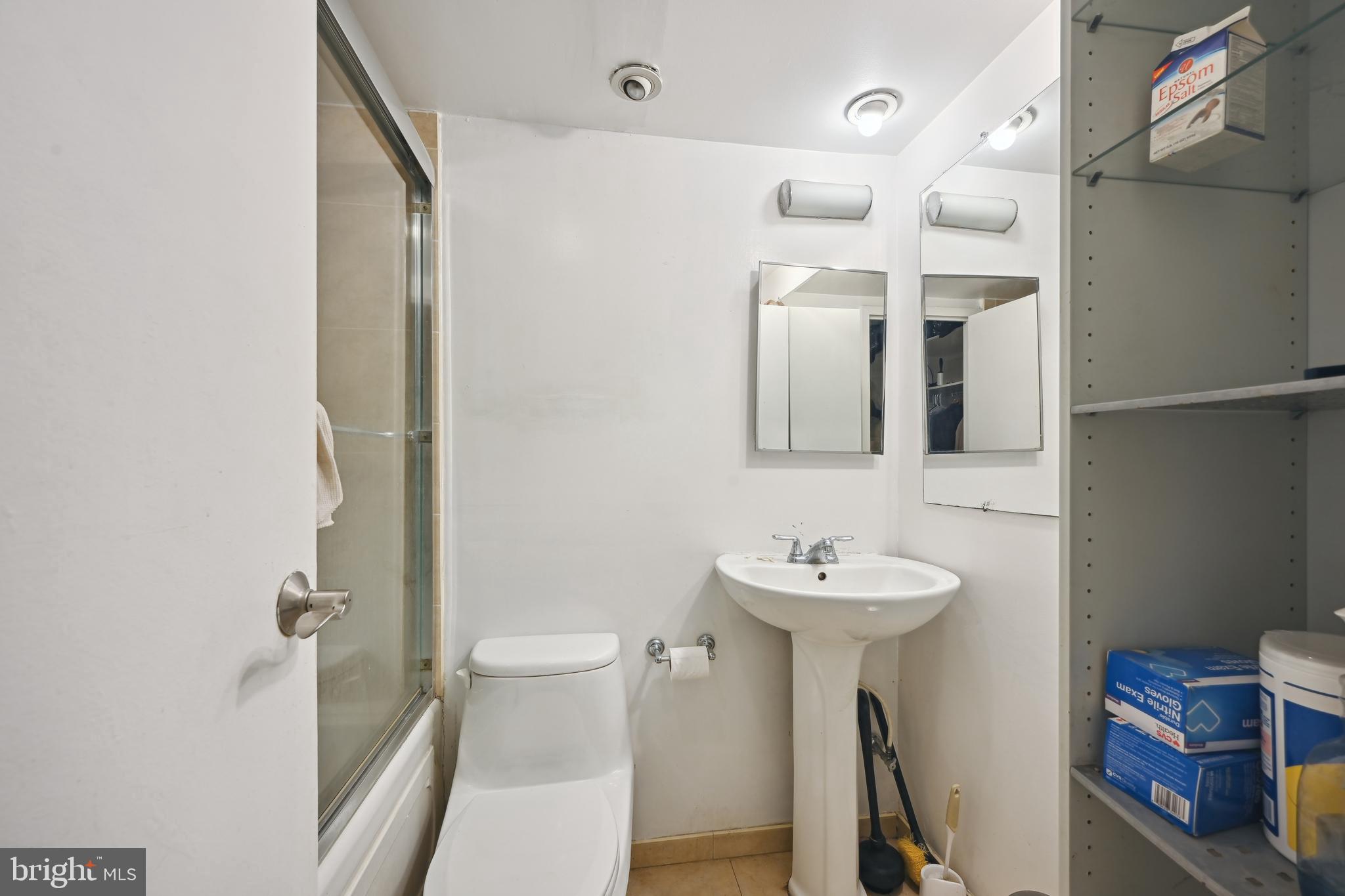 950 25th Street Northwest, Unit 814N Washington, DC 20037 - Photo 28 of 44 a bathroom with a sink a toilet and a mirror