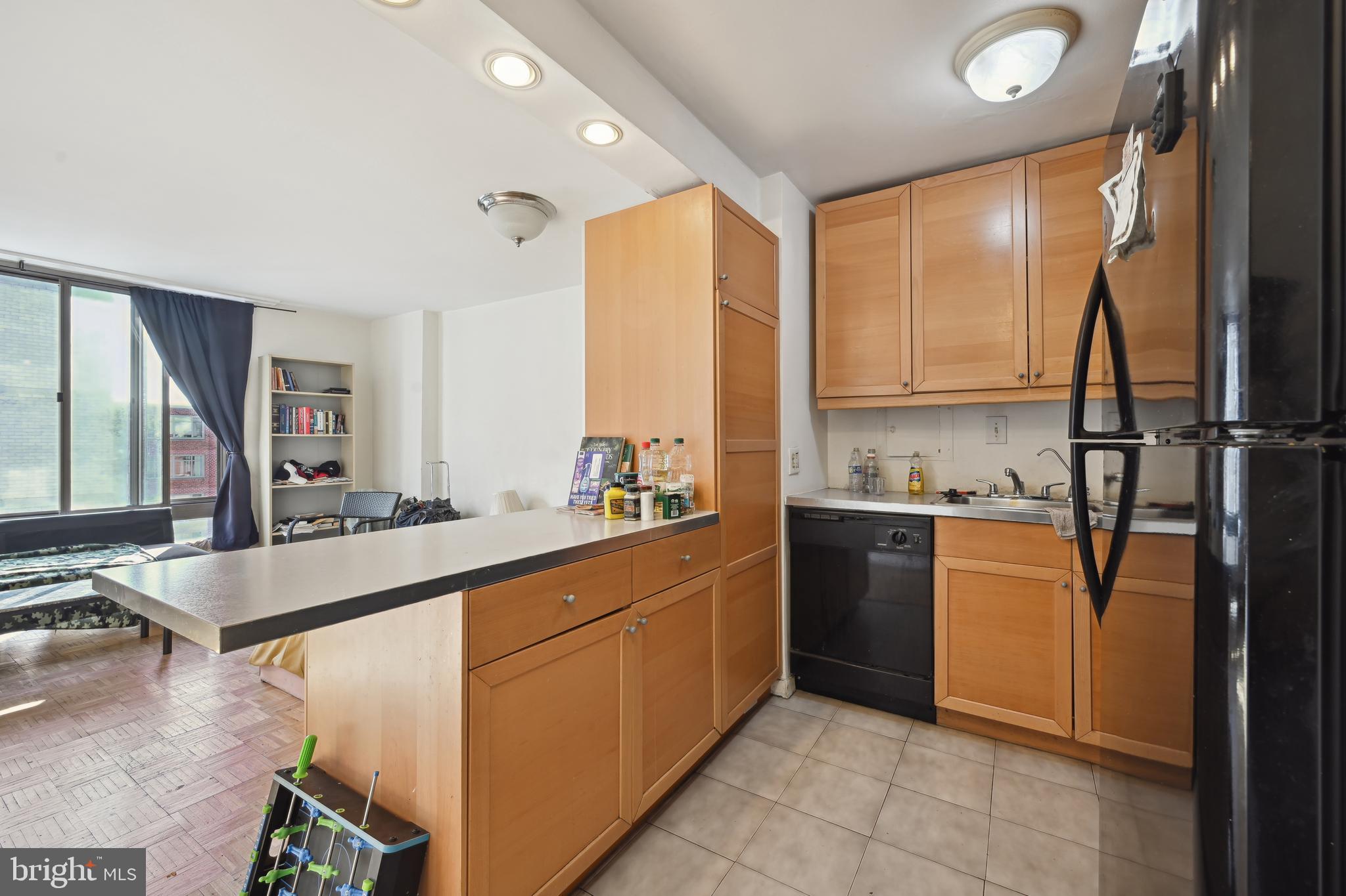 950 25th Street Northwest, Unit 814N Washington, DC 20037 - Photo 10 of 44 a kitchen with a sink refrigerator and cabinets
