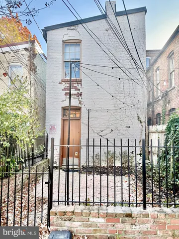 a view of a brick building next to a yard