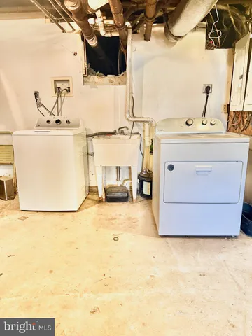 a utility room with a sink washer and dryer