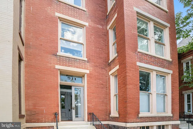 front view of a brick house with a large window