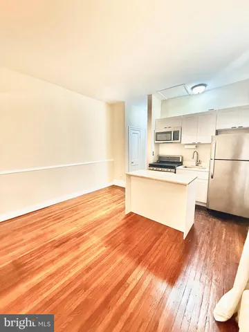 a kitchen with stainless steel appliances a refrigerator and a stove top oven