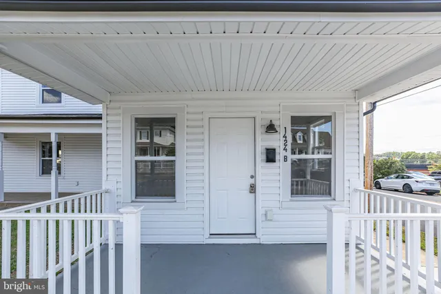 a view of porch with a chair and a gate