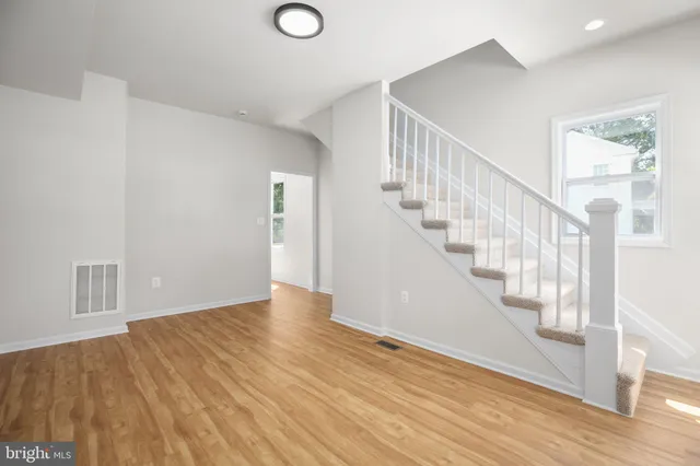 a view of an entryway with wooden floor
