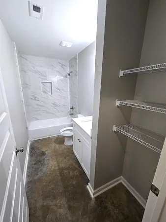 a bathroom with a shower and a toilet