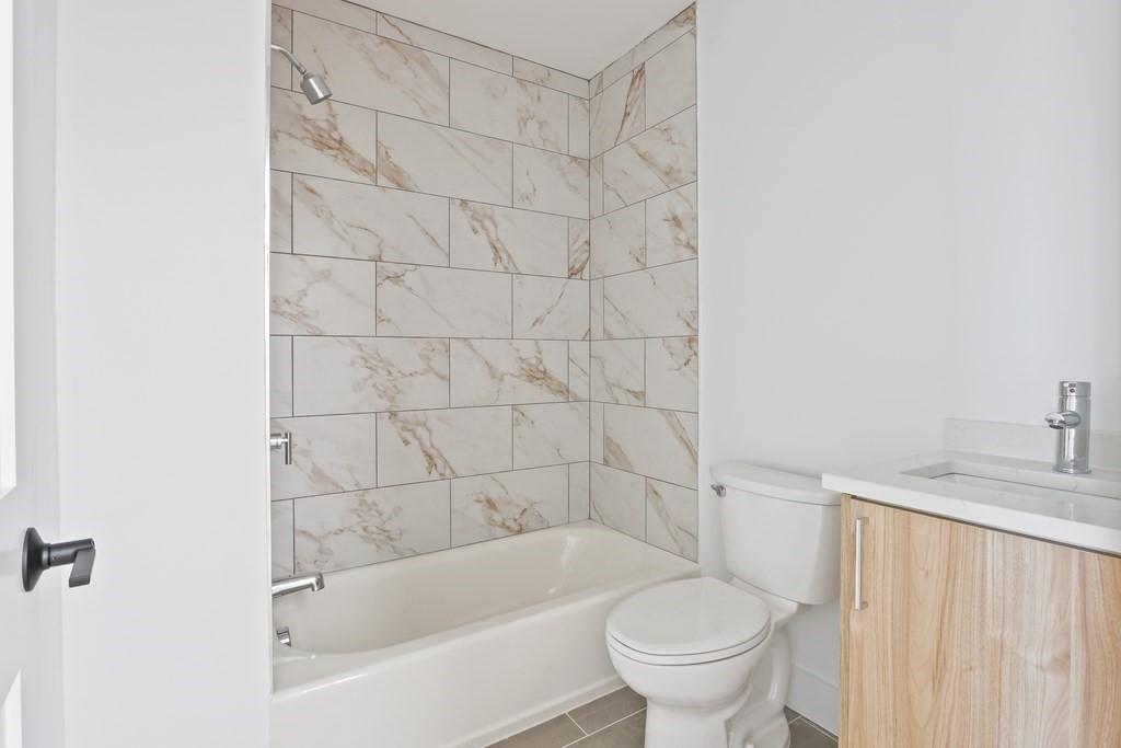 44 Cottage Street, Unit 2 Boston, MA 02128 - Photo 11 of 18 a bath room with a toilet and a bath tub