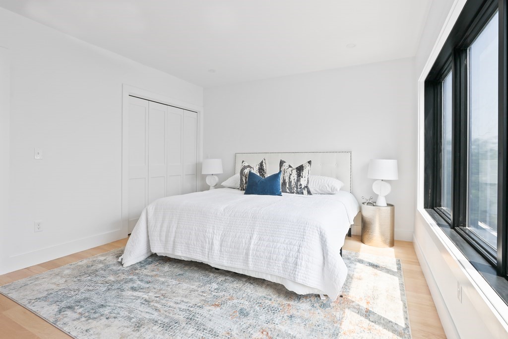 44 Cottage Street, Unit 2 Boston, MA 02128 - Photo 13 of 18 a large bed sitting in a bedroom next to a window