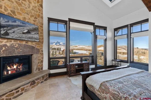 a bedroom with a bed and a fireplace