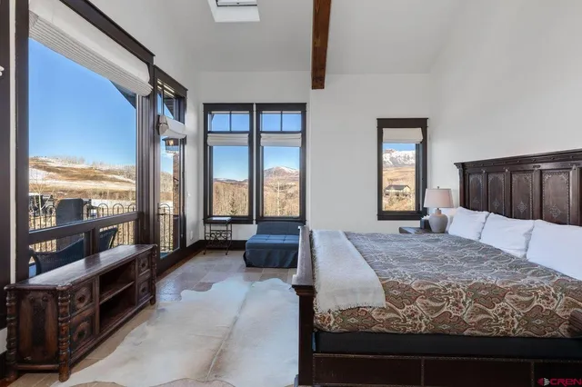 a bedroom with a large bed and a balcony view