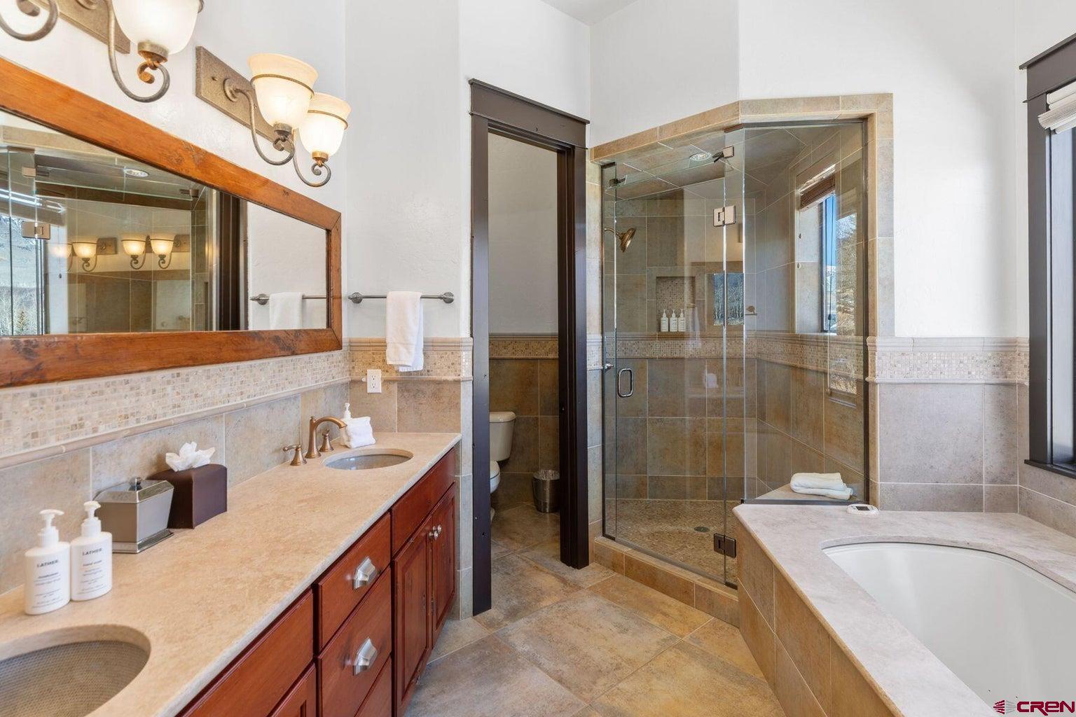 172 Adams Ranch Road Mountain Village, CO 81435 - Photo 13 of 29 a bathroom with a tub sink and mirror