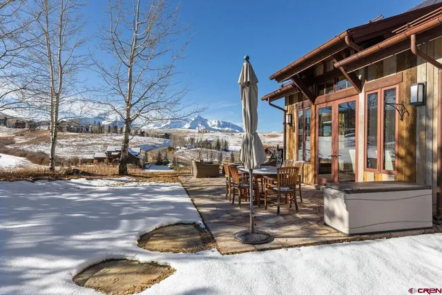 a view of a patio with a table and chairs