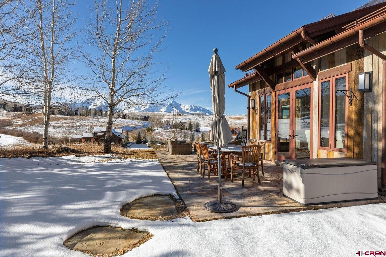 172 Adams Ranch Road Mountain Village, CO 81435 - Photo 15 of 29 a view of a patio with a table and chairs