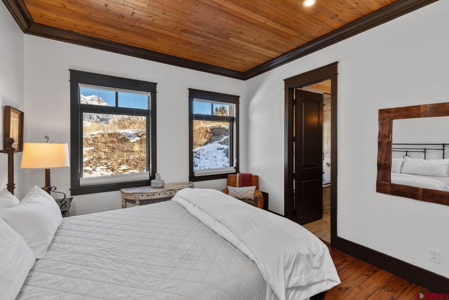 172 Adams Ranch Road Mountain Village, CO 81435 - Photo 21 of 29 a bedroom with a large bed and a large window