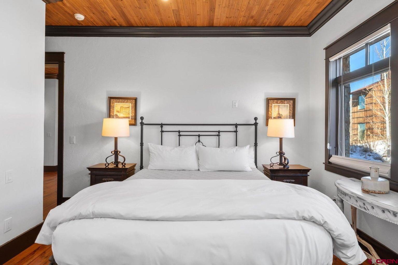 172 Adams Ranch Road Mountain Village, CO 81435 - Photo 23 of 29 a bedroom with a bed and lamps