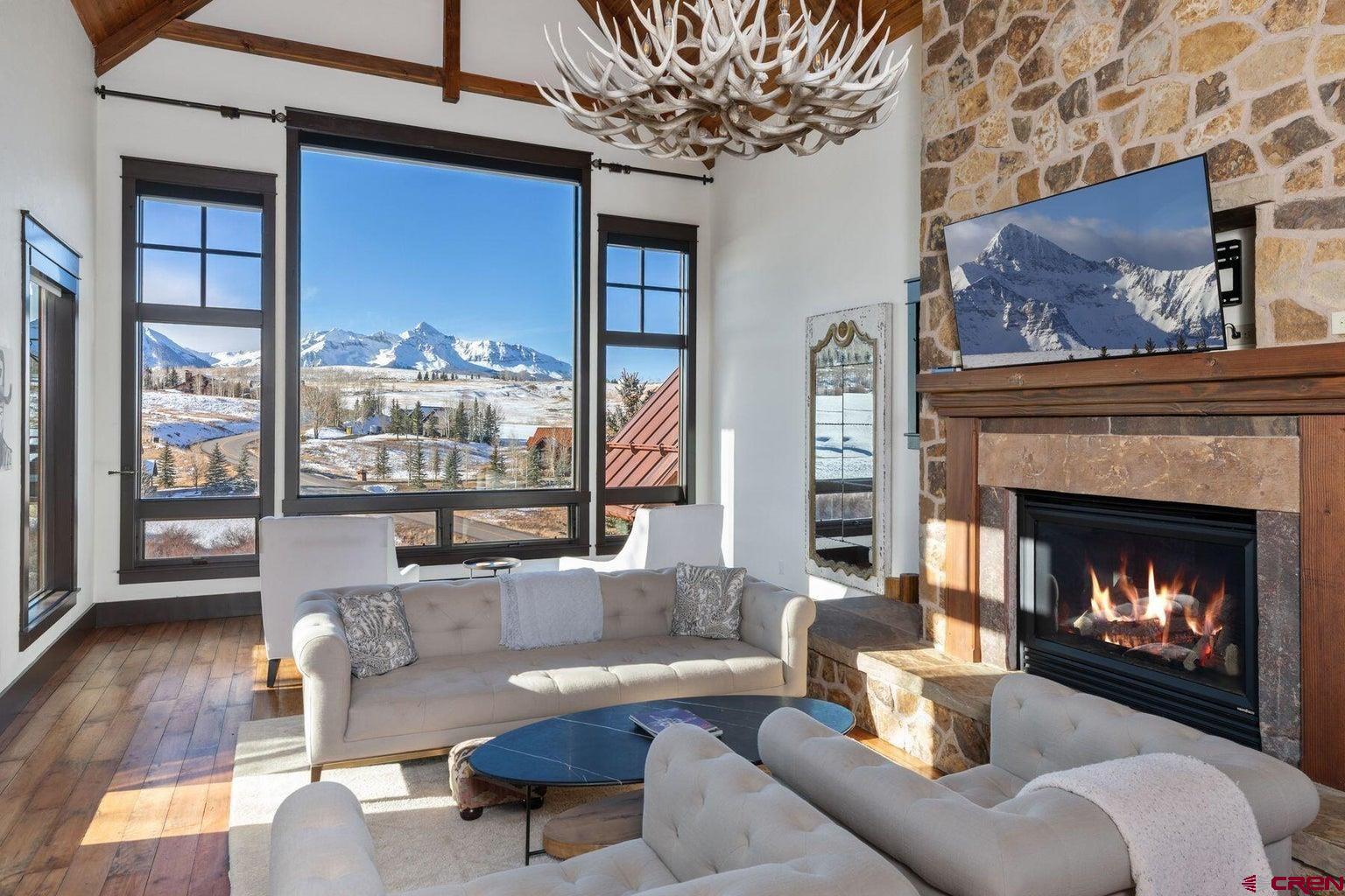 172 Adams Ranch Road Mountain Village, CO 81435 - Photo 3 of 29 a living room with furniture and a fireplace