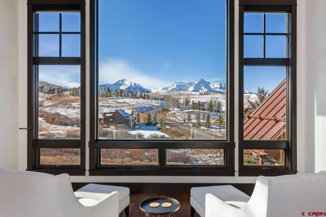 a view of a balcony with chair and city view