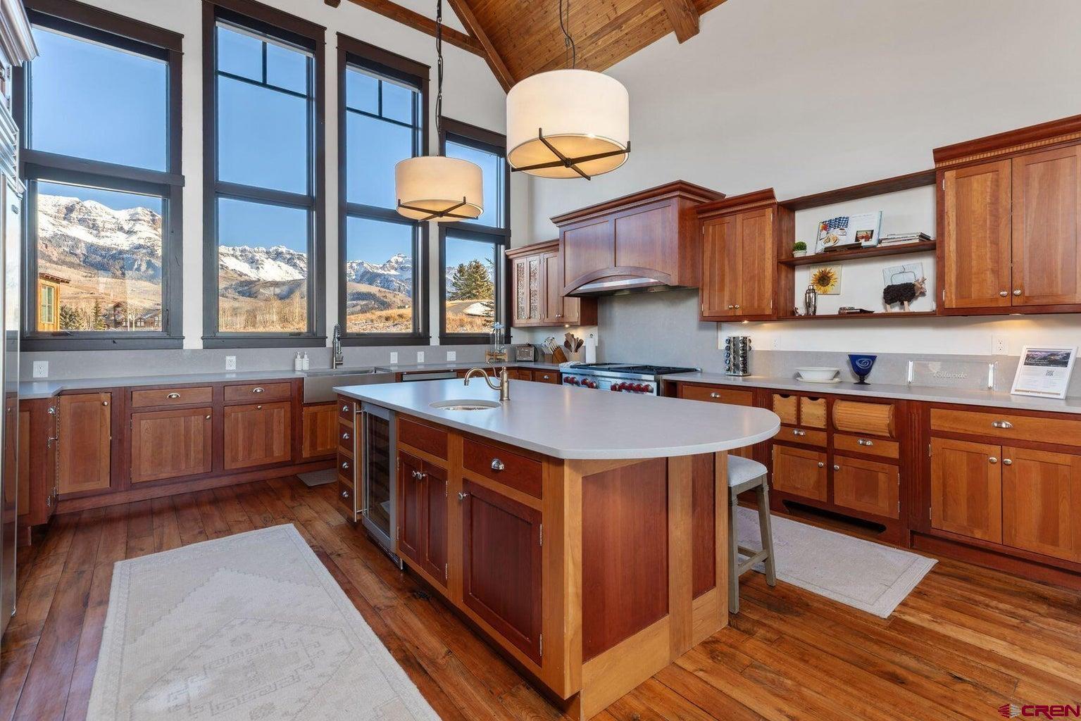 172 Adams Ranch Road Mountain Village, CO 81435 - Photo 8 of 29 a kitchen with stainless steel appliances granite countertop a sink a stove and a wooden floors