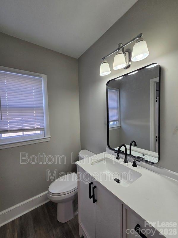 5949 Quail Hollow Road, Unit D Charlotte, NC 28210 - Photo 29 of 34 a bathroom with a toilet sink and mirror