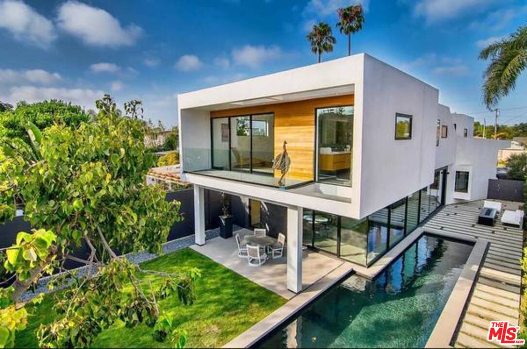 a view of house with swimming pool and chair