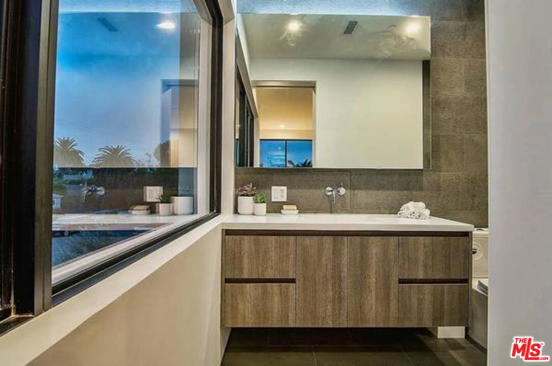 2021 Walnut Avenue Venice, CA 90291 - Photo 13 of 23 a bathroom with a sink and a mirror