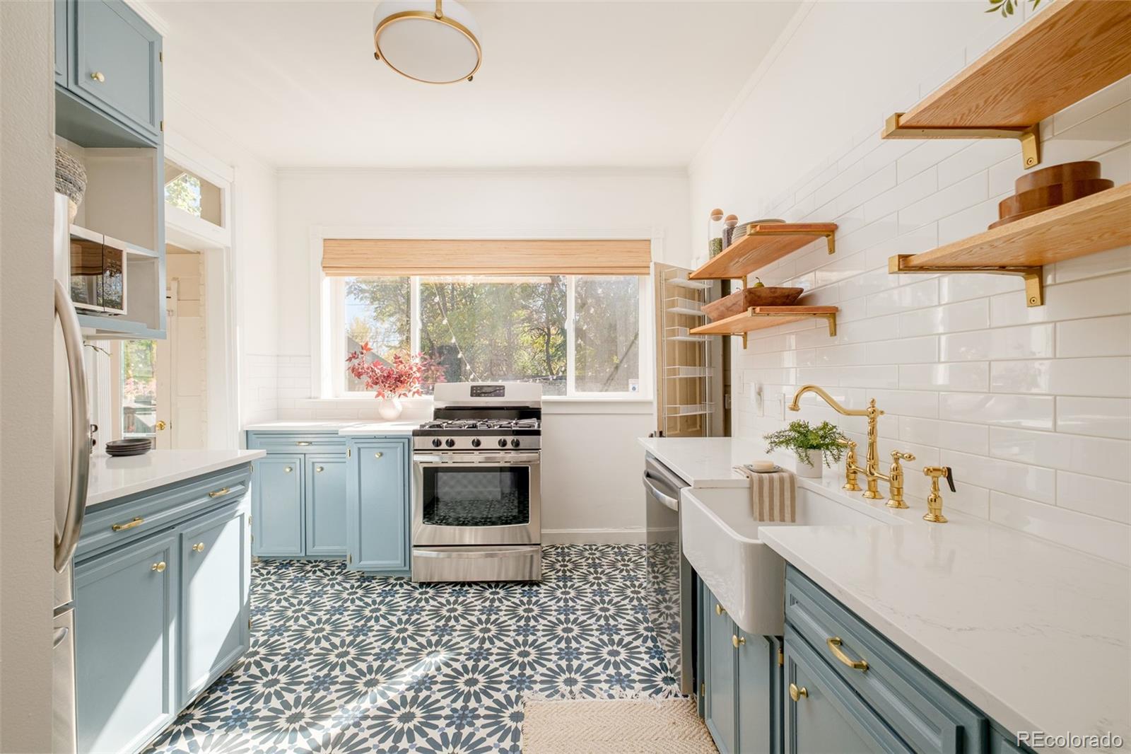 3042 West 24th Avenue Denver, CO 80211 - Photo 13 of 32 a kitchen with a sink appliances cabinets and a large window