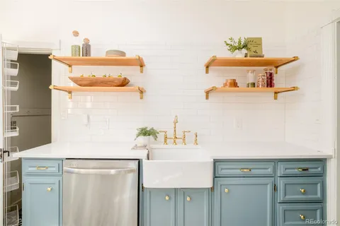 a kitchen with a sink cabinets and appliances