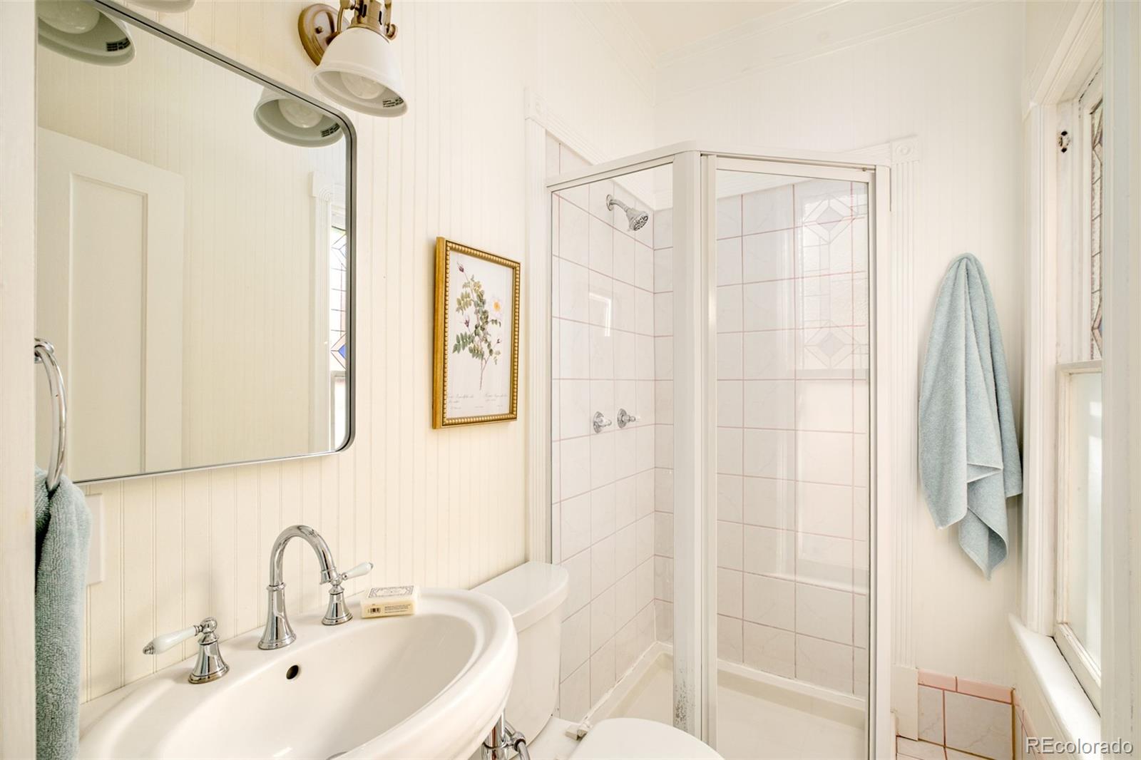 3042 West 24th Avenue Denver, CO 80211 - Photo 16 of 32 a bathroom with a sink a toilet and shower