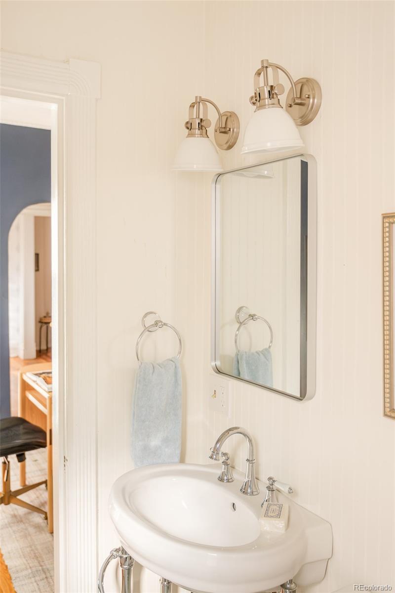 3042 West 24th Avenue Denver, CO 80211 - Photo 17 of 32 a bathroom with a sink and a mirror