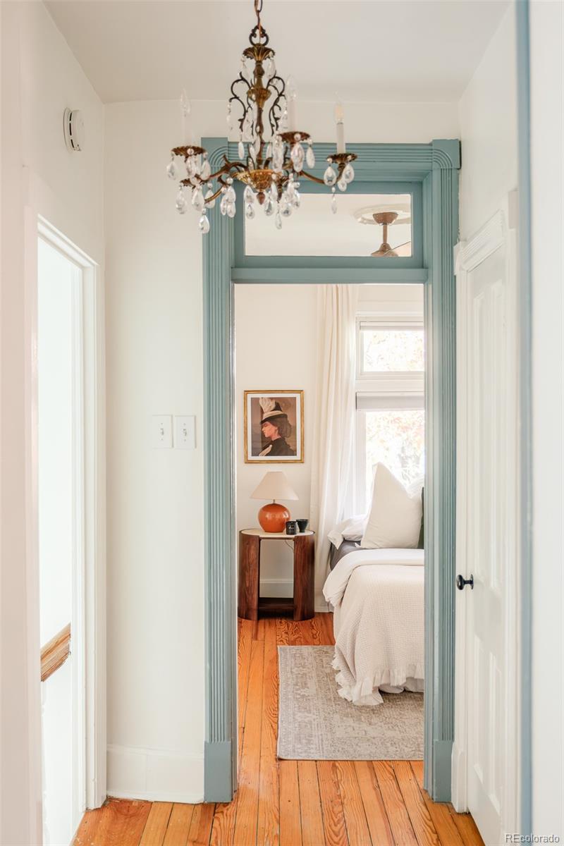 3042 West 24th Avenue Denver, CO 80211 - Photo 20 of 32 a bedroom with a bed and wooden floor