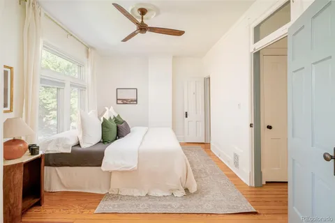 a living room with a bed and a rug