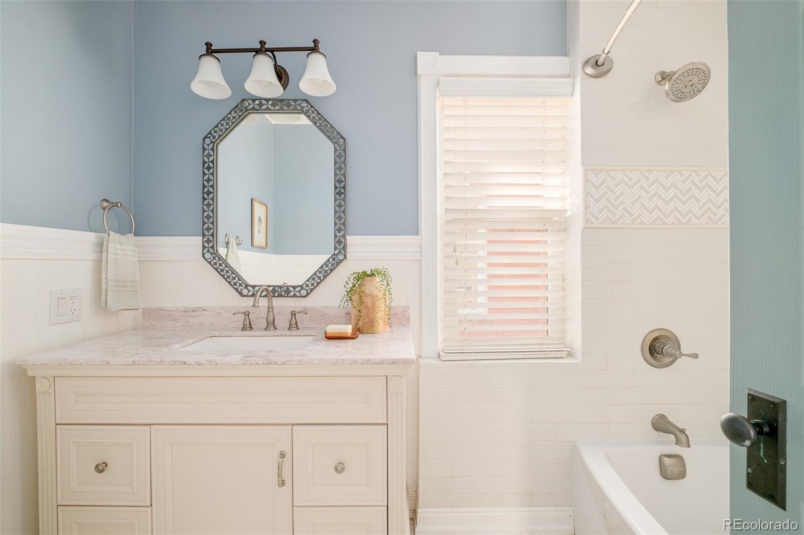 3042 West 24th Avenue Denver, CO 80211 - Photo 25 of 32 a bathroom with a sink a toilet and shower