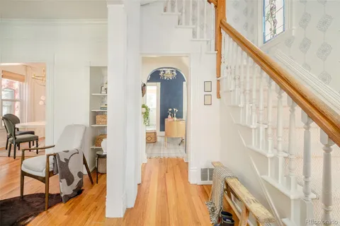 a view of a living room with furniture and wooden floor