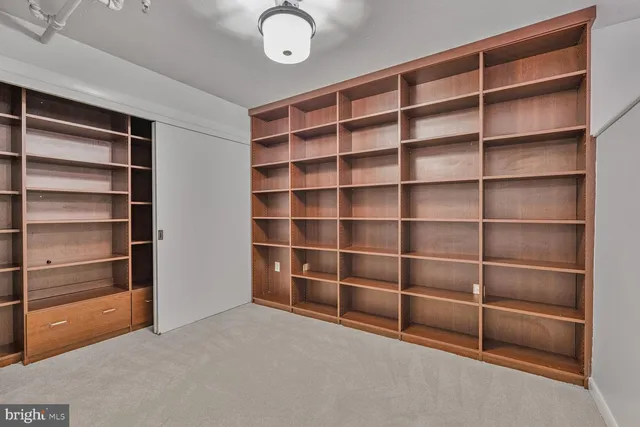 a view of an empty room with empty shelves