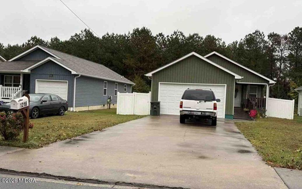 1216 Frazier Drive Dalton, GA 30721 - Photo 1 of 1 a car parked in front of white house
