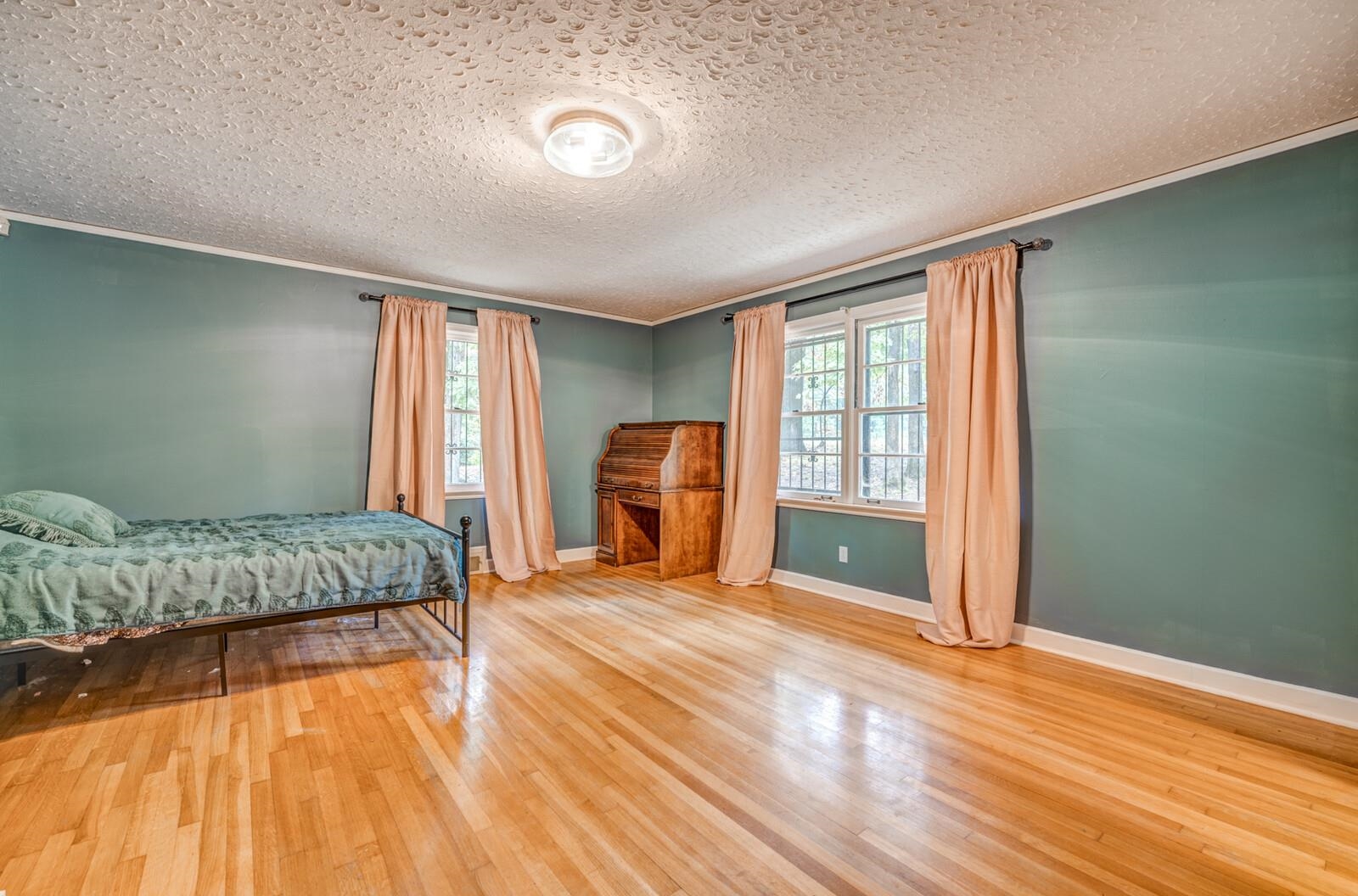 2725 Covington Pike Memphis, TN 38128 - Photo 3 of 26 a bedroom with a bed and wooden floor