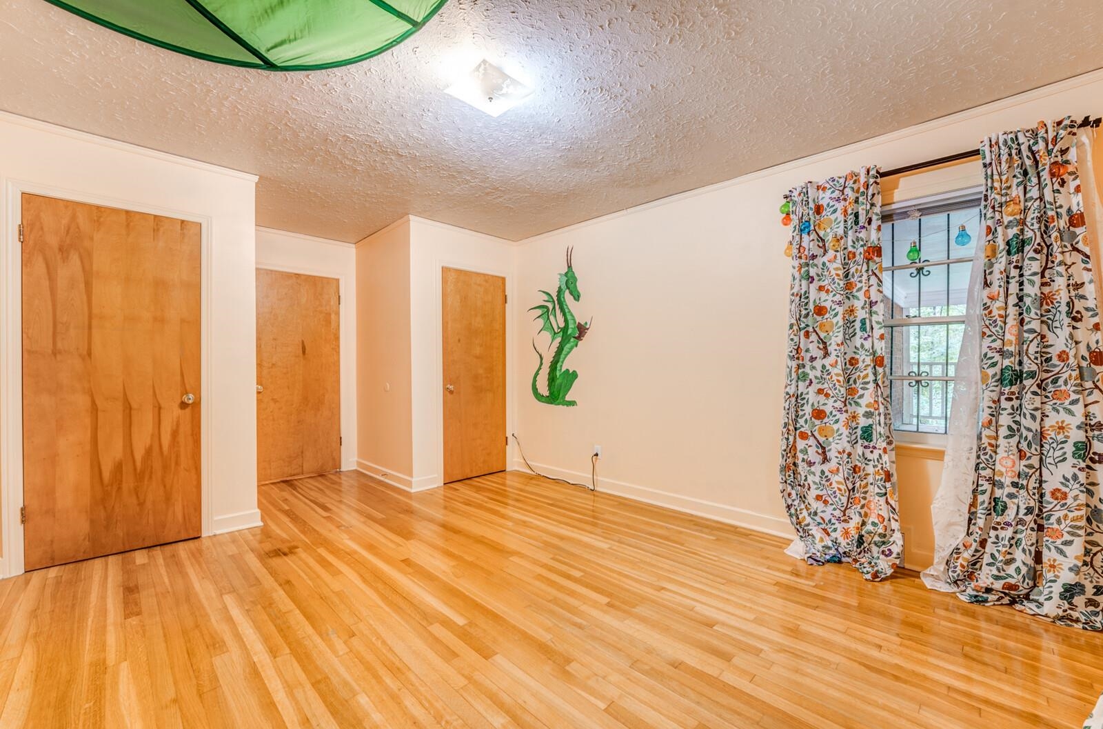 2725 Covington Pike Memphis, TN 38128 - Photo 4 of 26 a view of an empty room with window and wooden floor