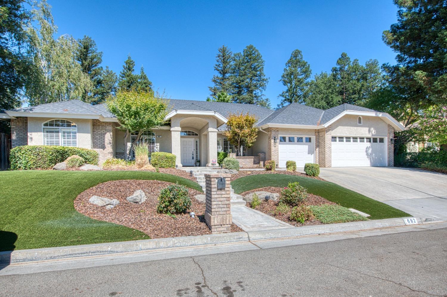 692 East Blue Ridge Road Fresno, CA 93725 - Photo 11 of 68 a front view of a house with garden