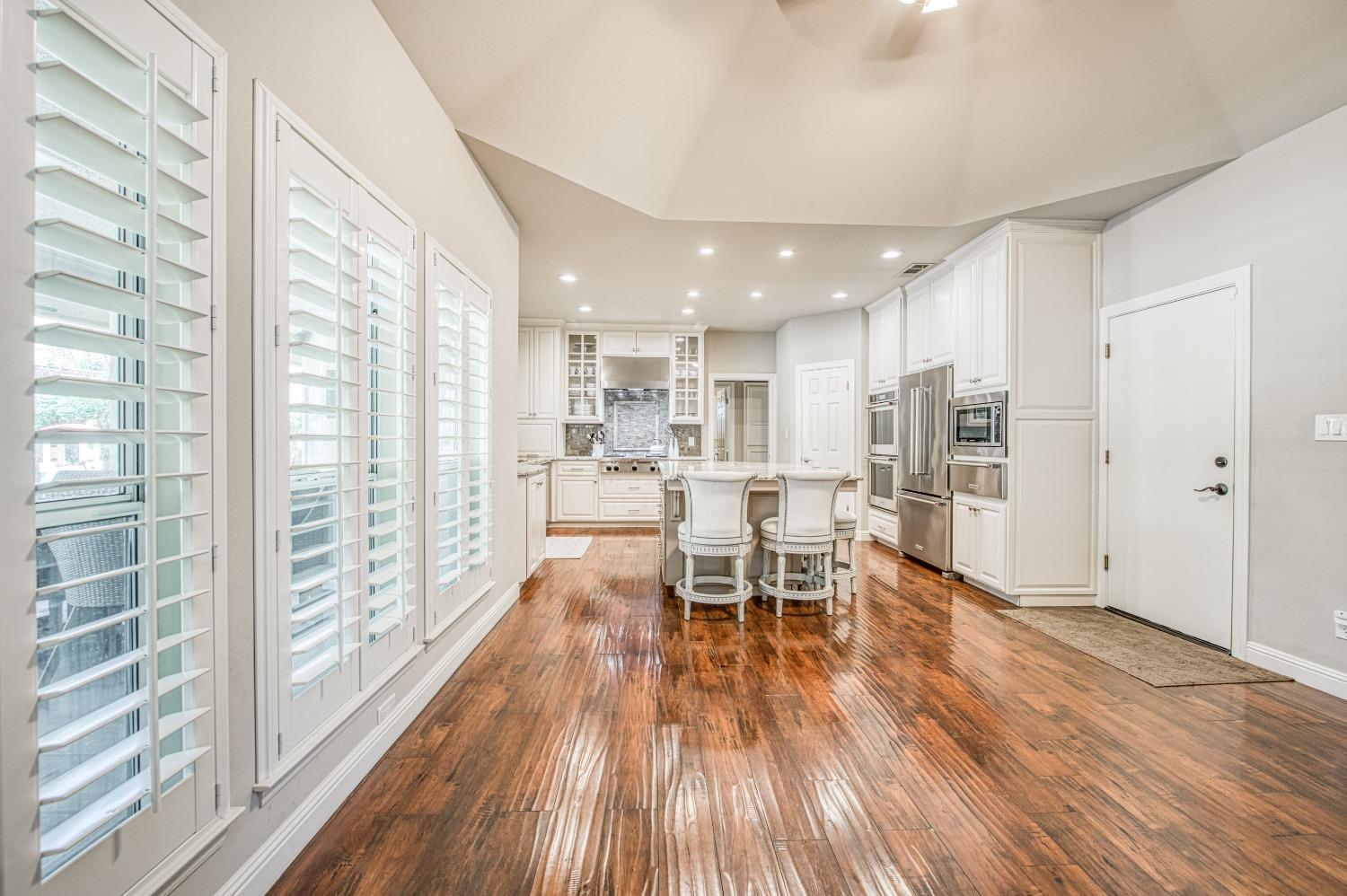 692 East Blue Ridge Road Fresno, CA 93725 - Photo 19 of 68 a view of a kitchen with dining room and wooden floor