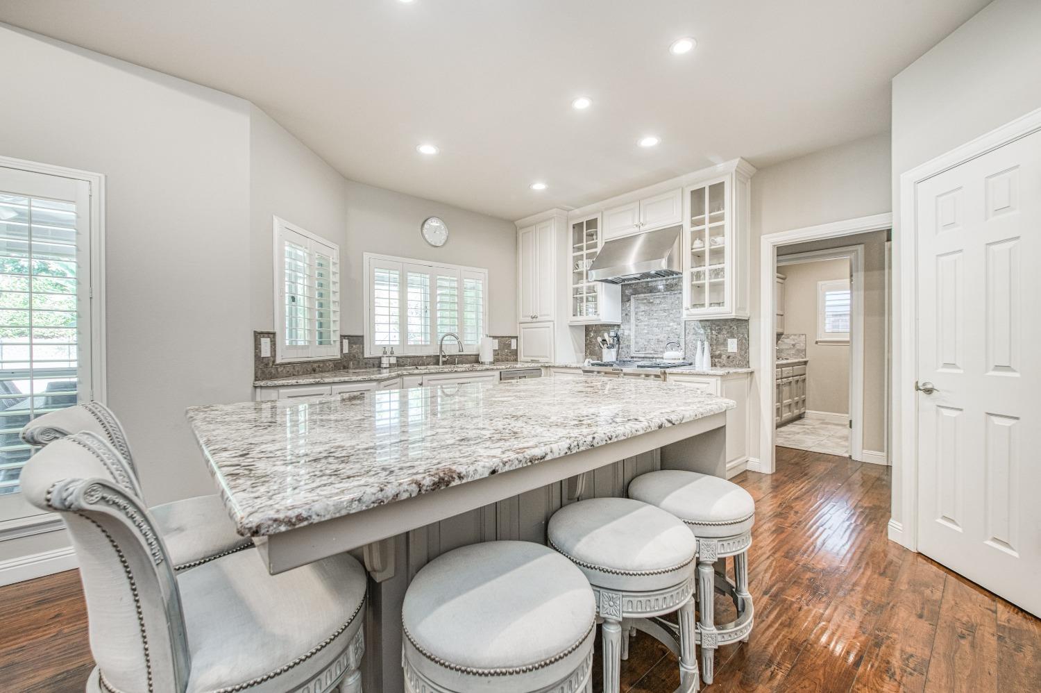 692 East Blue Ridge Road Fresno, CA 93725 - Photo 21 of 68 a kitchen with a table chairs sink and cabinets