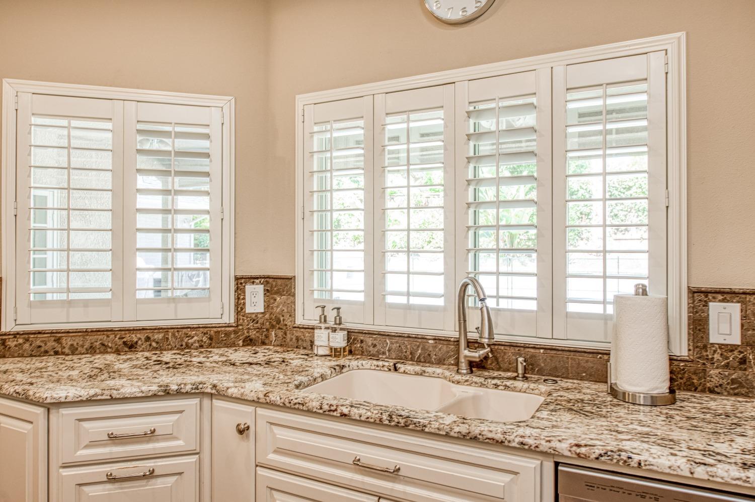 692 East Blue Ridge Road Fresno, CA 93725 - Photo 24 of 68 a kitchen with a granite countertop sink and a window